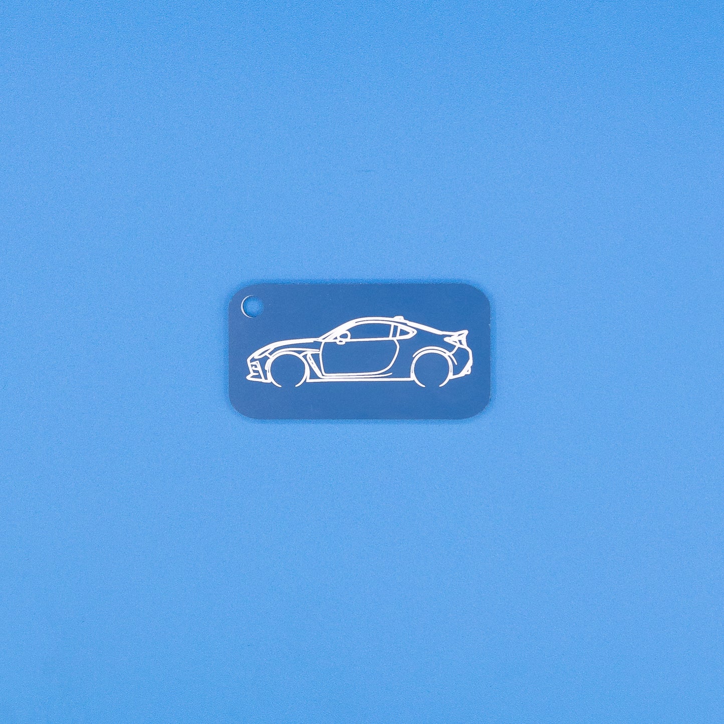 Toyota GR86 Keychain in Light blue on blue background