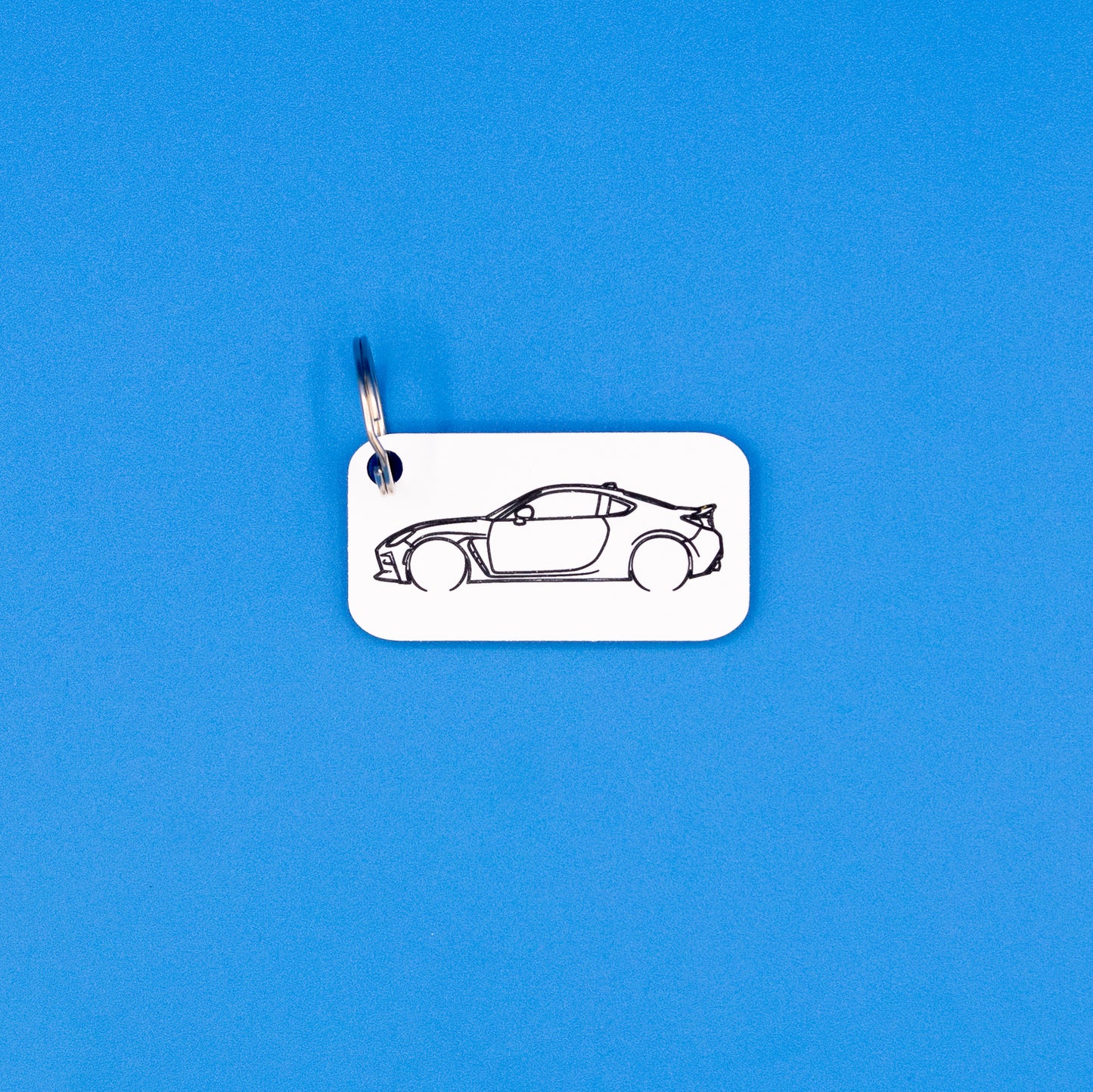 Toyota GR86 Acrylic keychain with key ring on a blue background