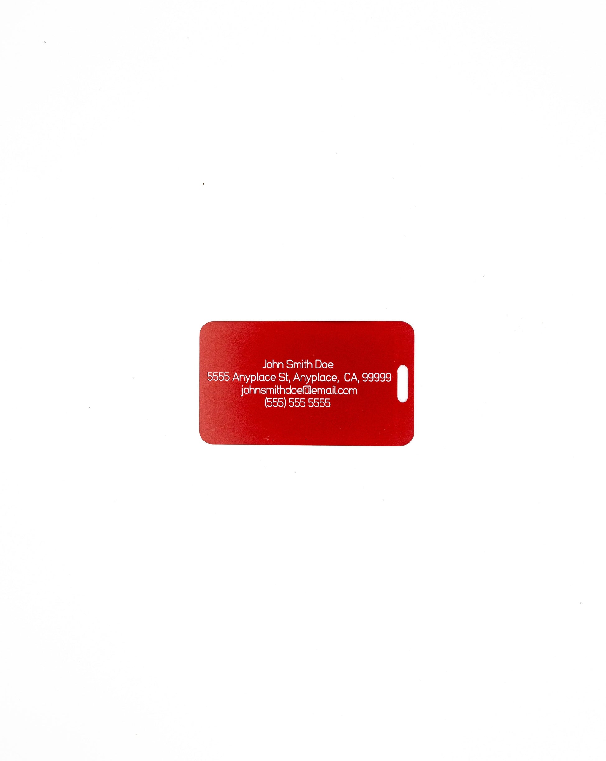 Rear of acrylic luggage tag in red with information.
