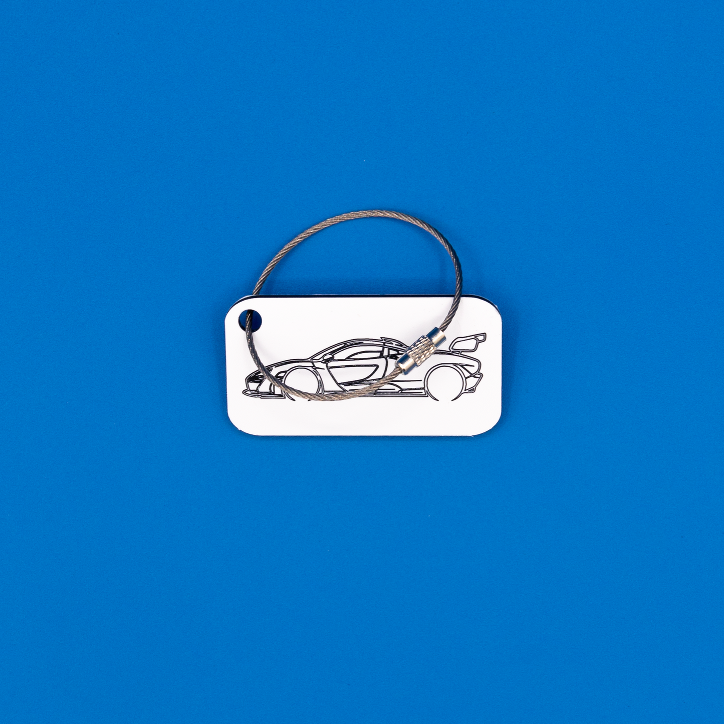 McLaren Senna Acrylic Keychain in white with a wire loop.