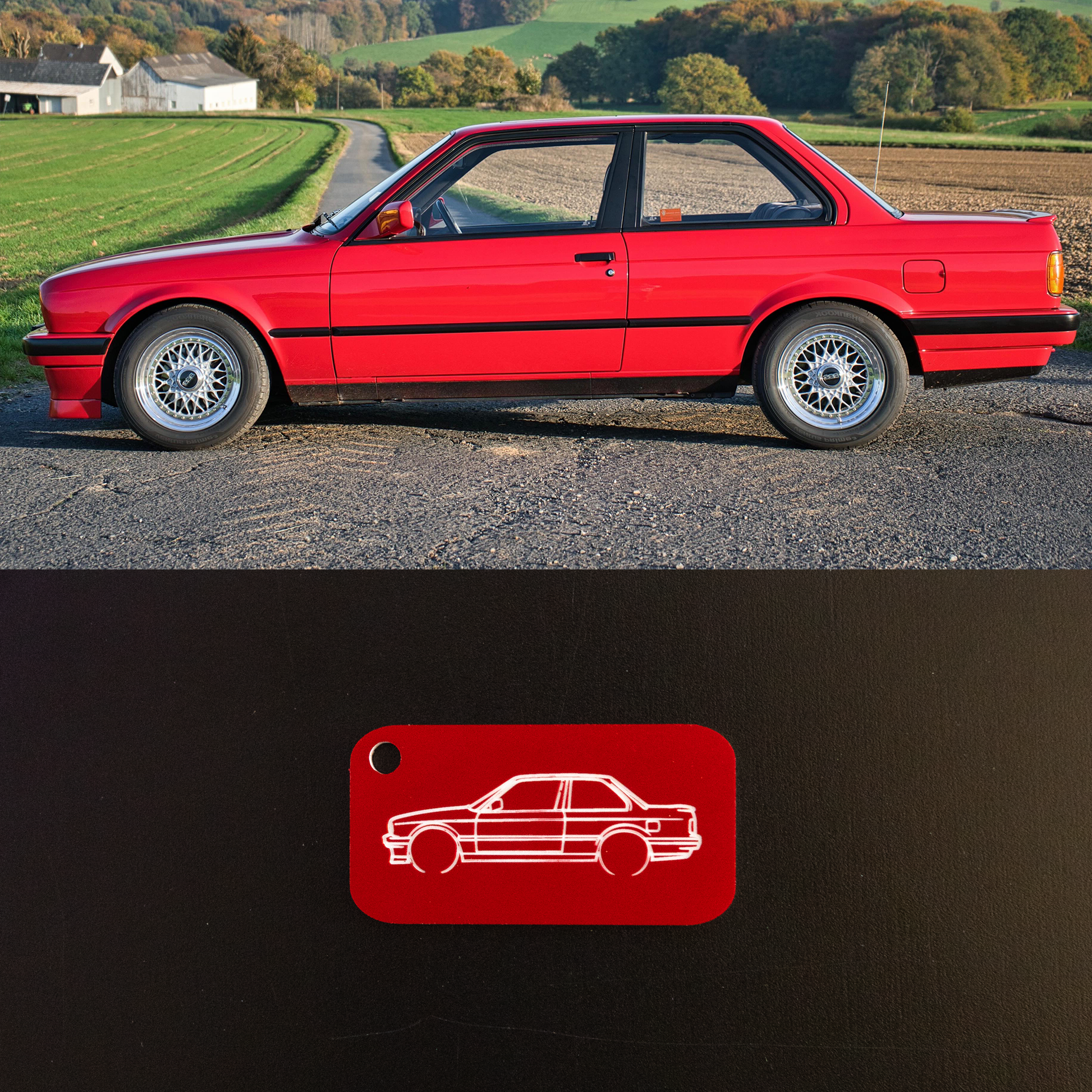 Red BMW E30 parked on a road with a scenic background, featuring a red and white logo at the bottom.