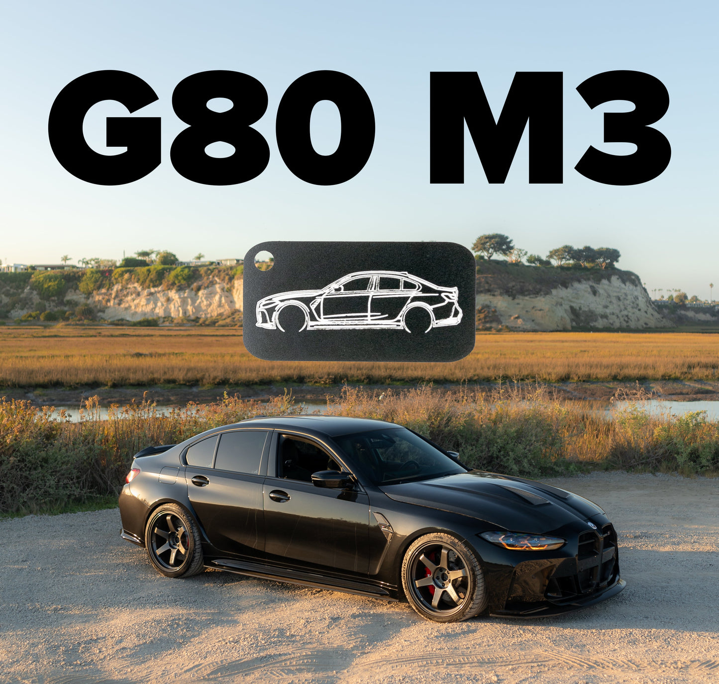 Picture of G80 M3 Acrylic Keychain in black with G80 M3 in background.