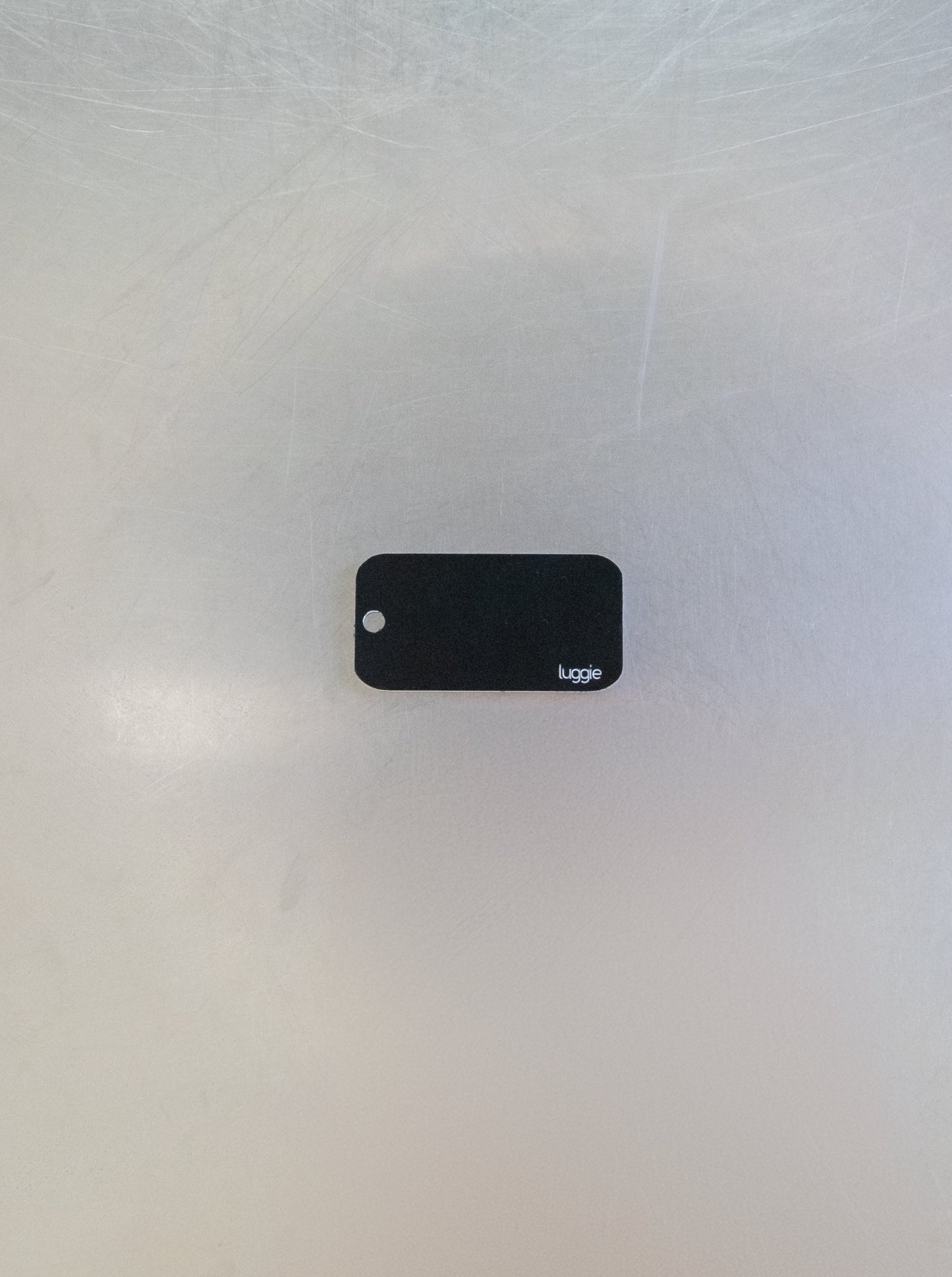 rear of custom key tag with luggie branding