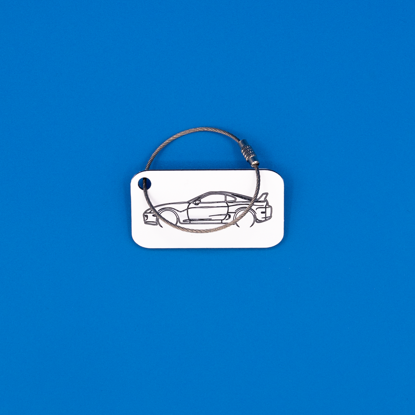 Toyota Supra Acrylic Keychain in white with a wire loop.