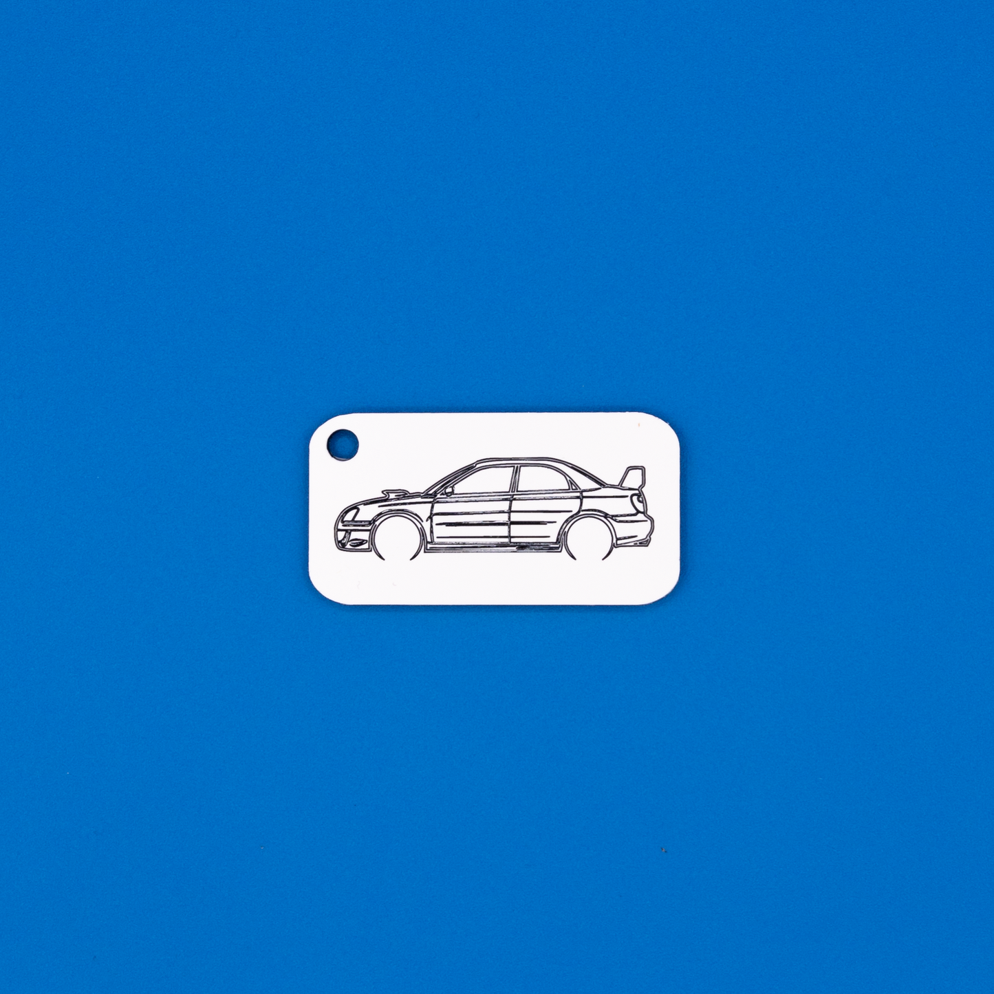 Subaru WRX STi Acrylic Keychain in white with just the hole.