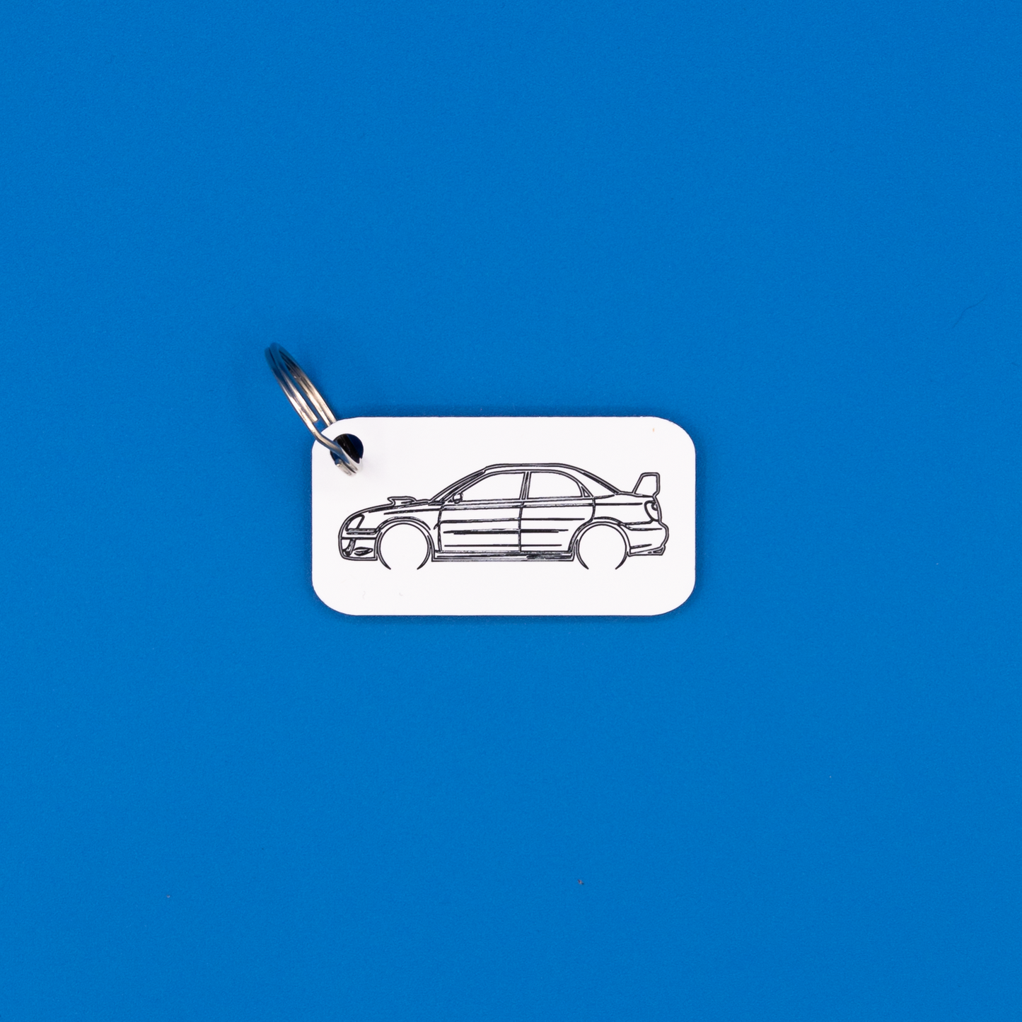 Subaru WRX STi Acrylic Keychain in white with a classic key ring.