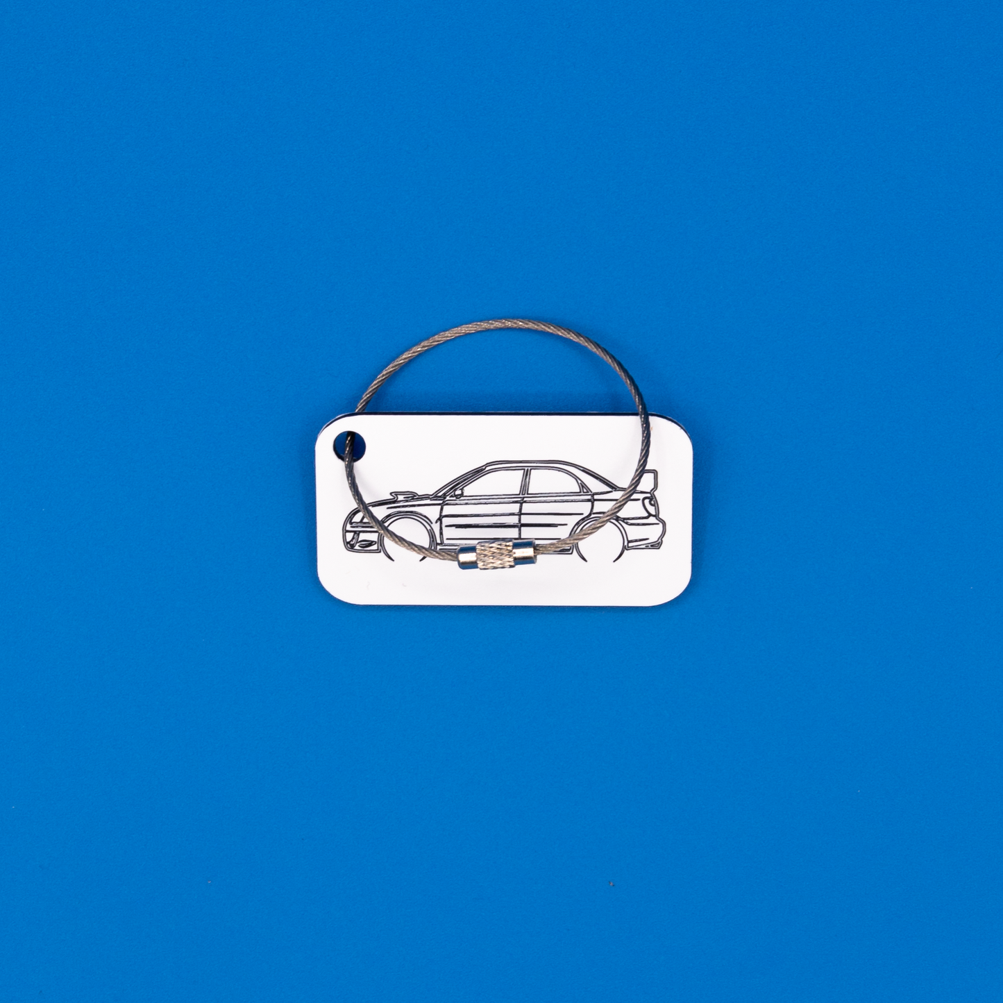 Subaru WRX STi Acrylic Keychain in white with a wire loop.
