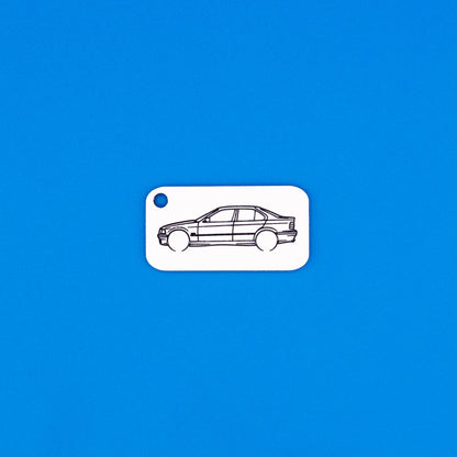 acrylic keychain with BMW e36 sedan design on a blue background
