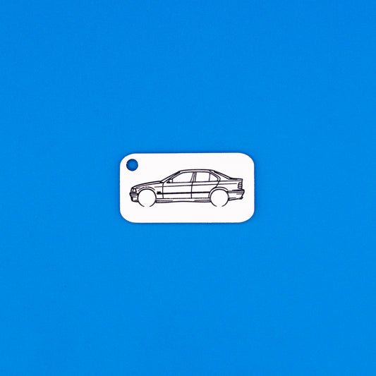 acrylic keychain with BMW e36 sedan design on a blue background