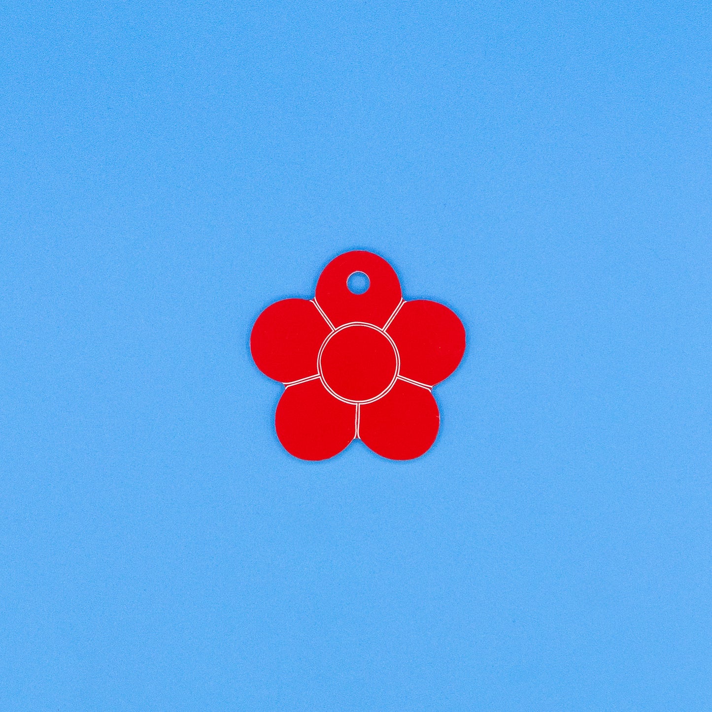 Red flower-shaped object on a blue background
