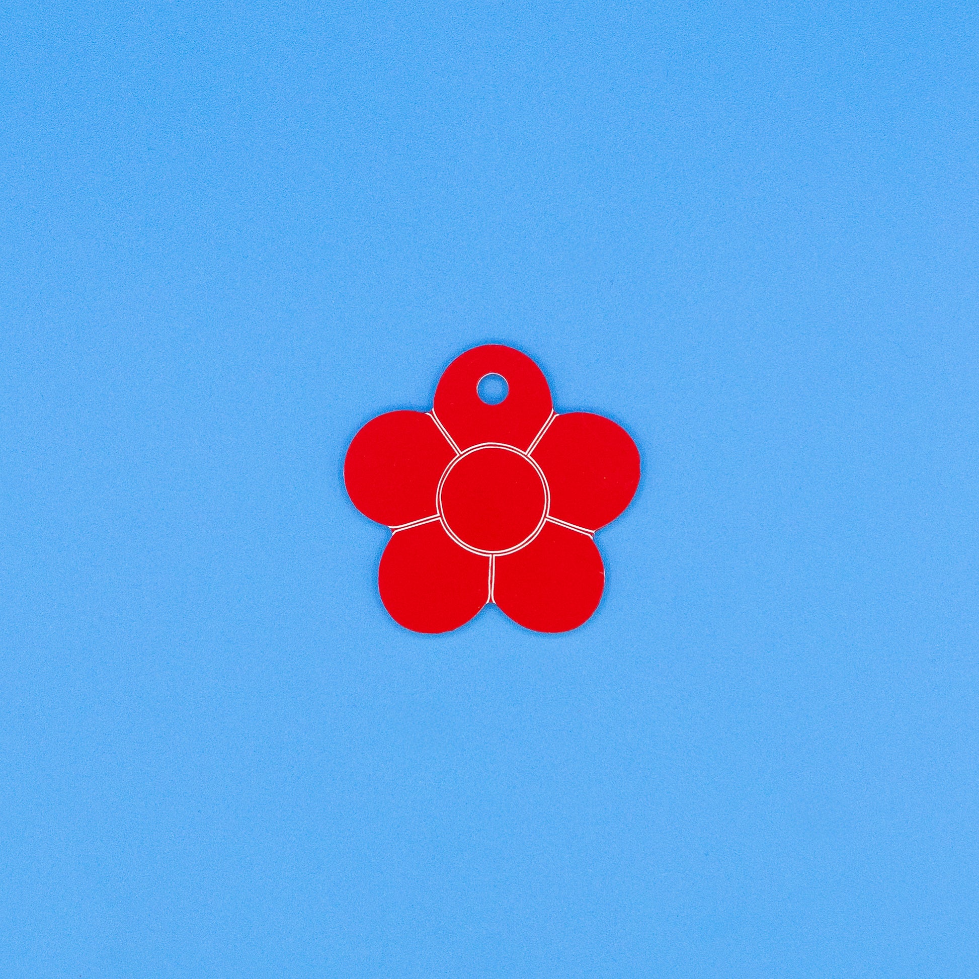 Red flower-shaped object on a blue background