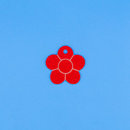 Red flower-shaped object on a blue background