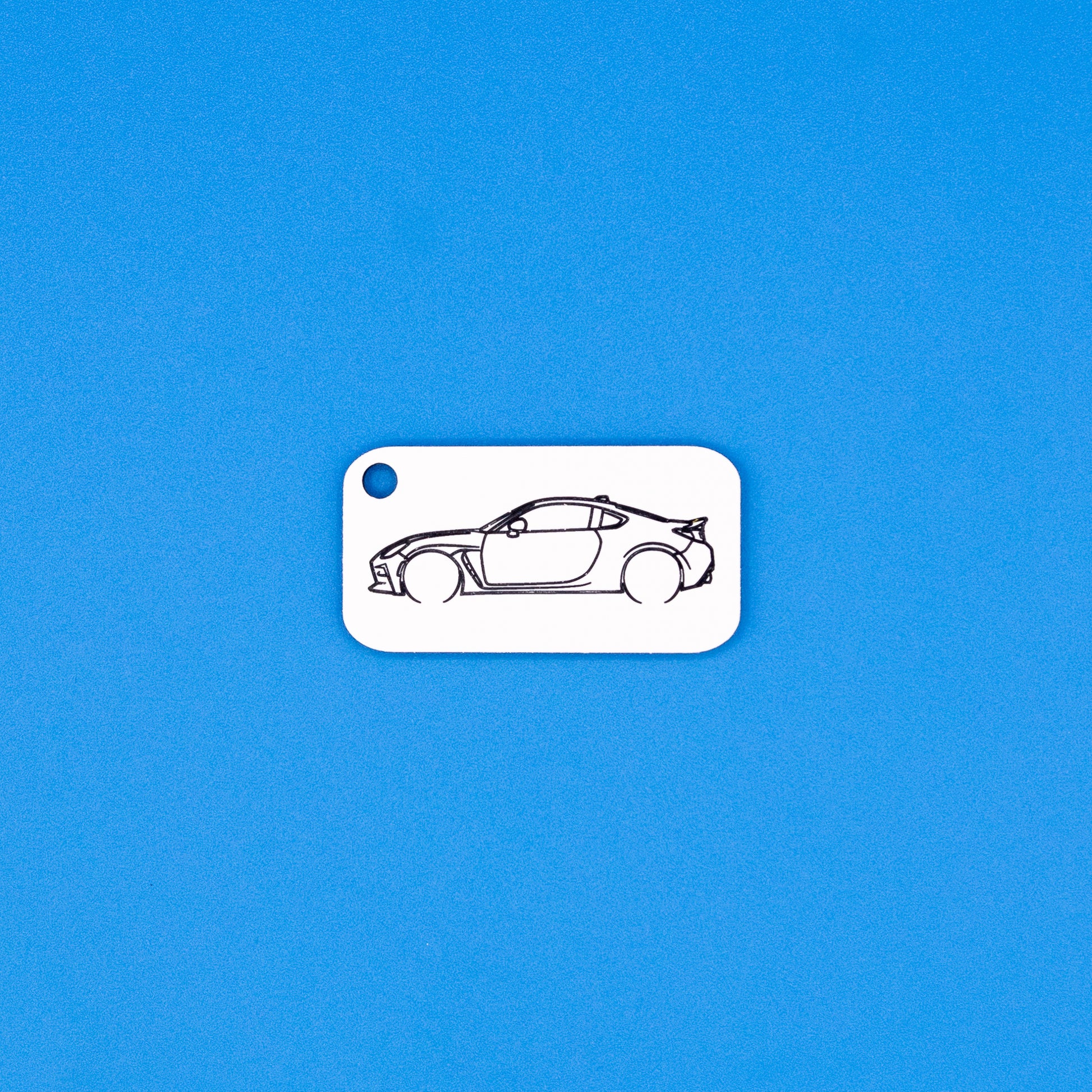 Toyota GR86 car keychain on a blue background