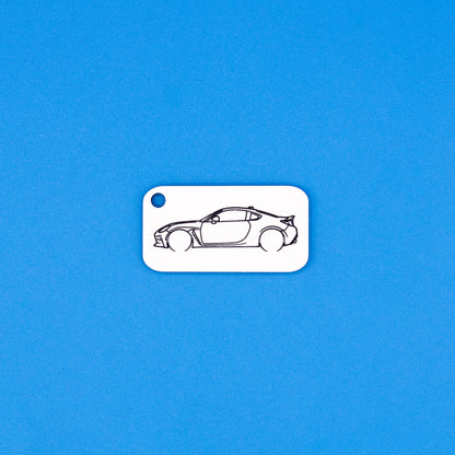 Toyota GR86 car keychain on a blue background
