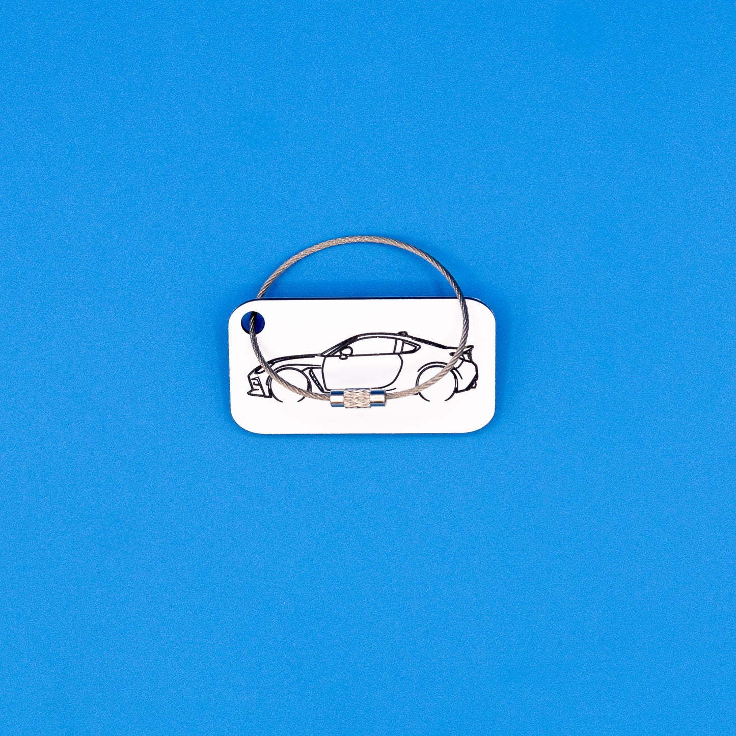 Toyota GR86 with wire loop keychain on a blue background