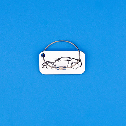 Toyota GR86 with wire loop keychain on a blue background
