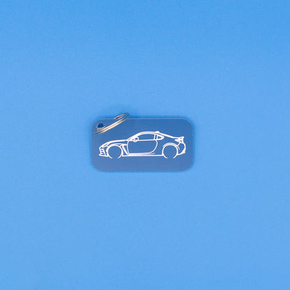 Toyota GR86 Keychain with classic key ring on blue background