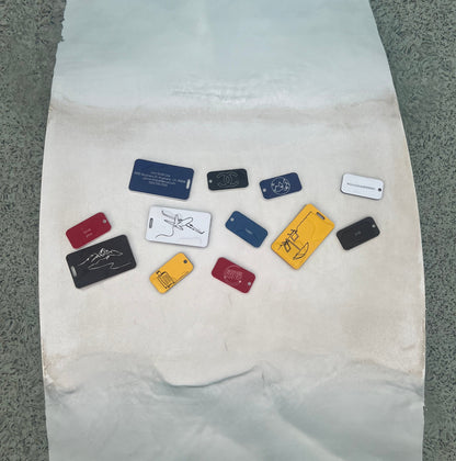 Keychains and luggage tags in water with luggage design keychain in yellow. 