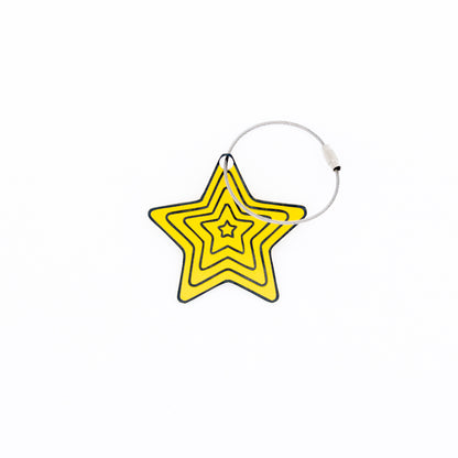 Yellow star-shaped keychain with wire loop on a white background