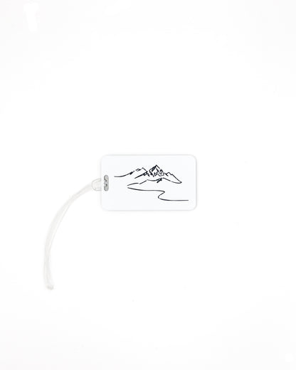 Mountain Design acrylic luggage tag in white with worm loop.