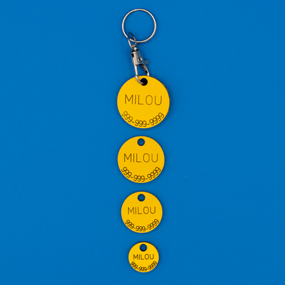 Circular Pet ID Tags in all sizes in yellow with strap. 