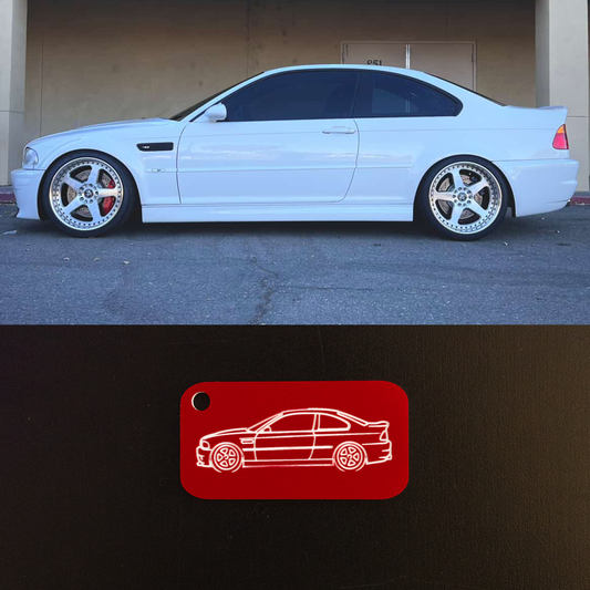 White BMW E46 M3 parked in a garage with a red car outline icon on a black background