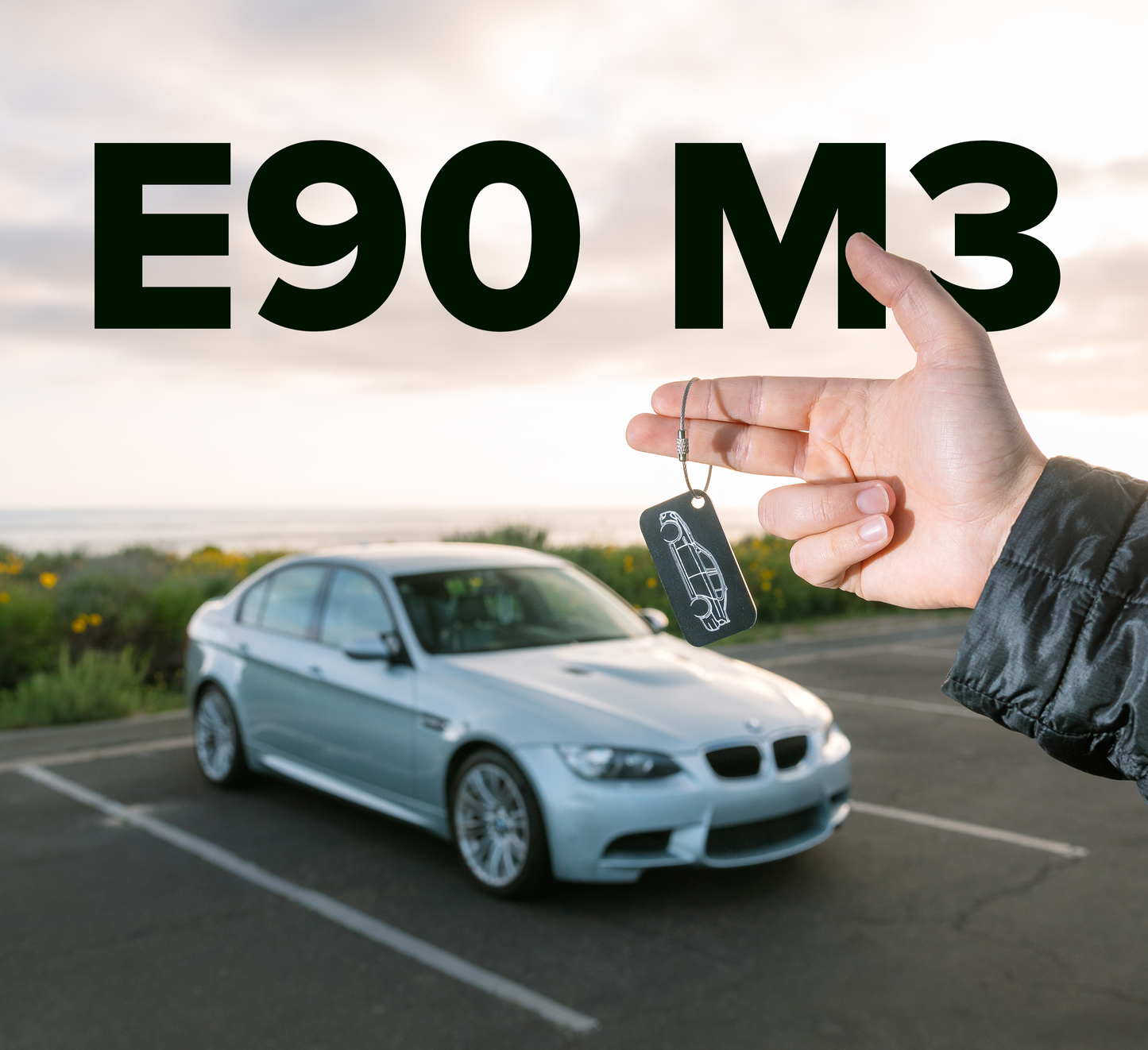 Picture of E90 M3 Acrylic Keychain in black with E90 M3 in background. 