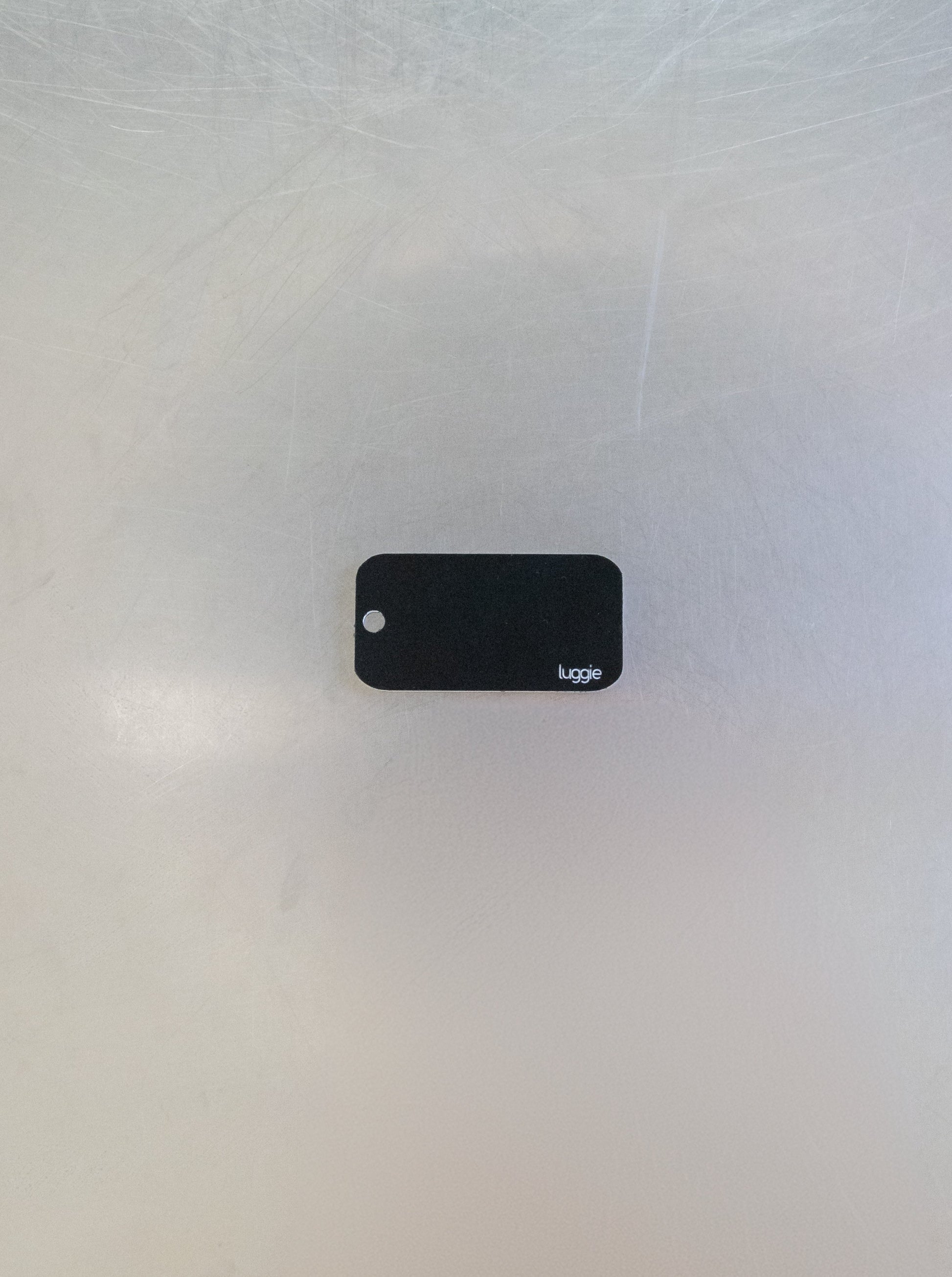 rear of custom key tag with luggie branding