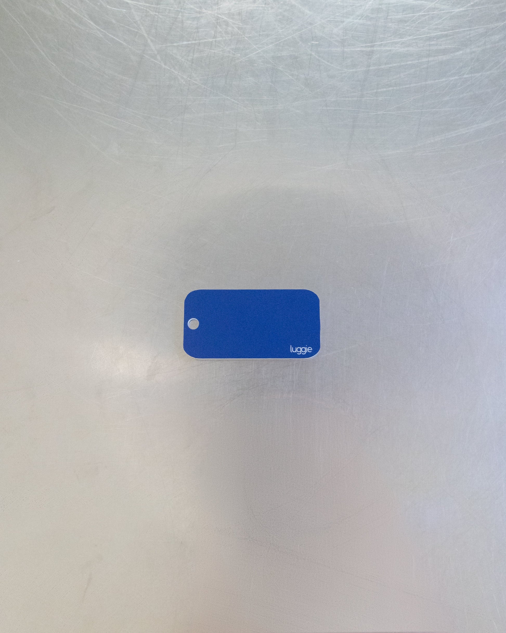 rear of dark blue custom key tag with luggie branding