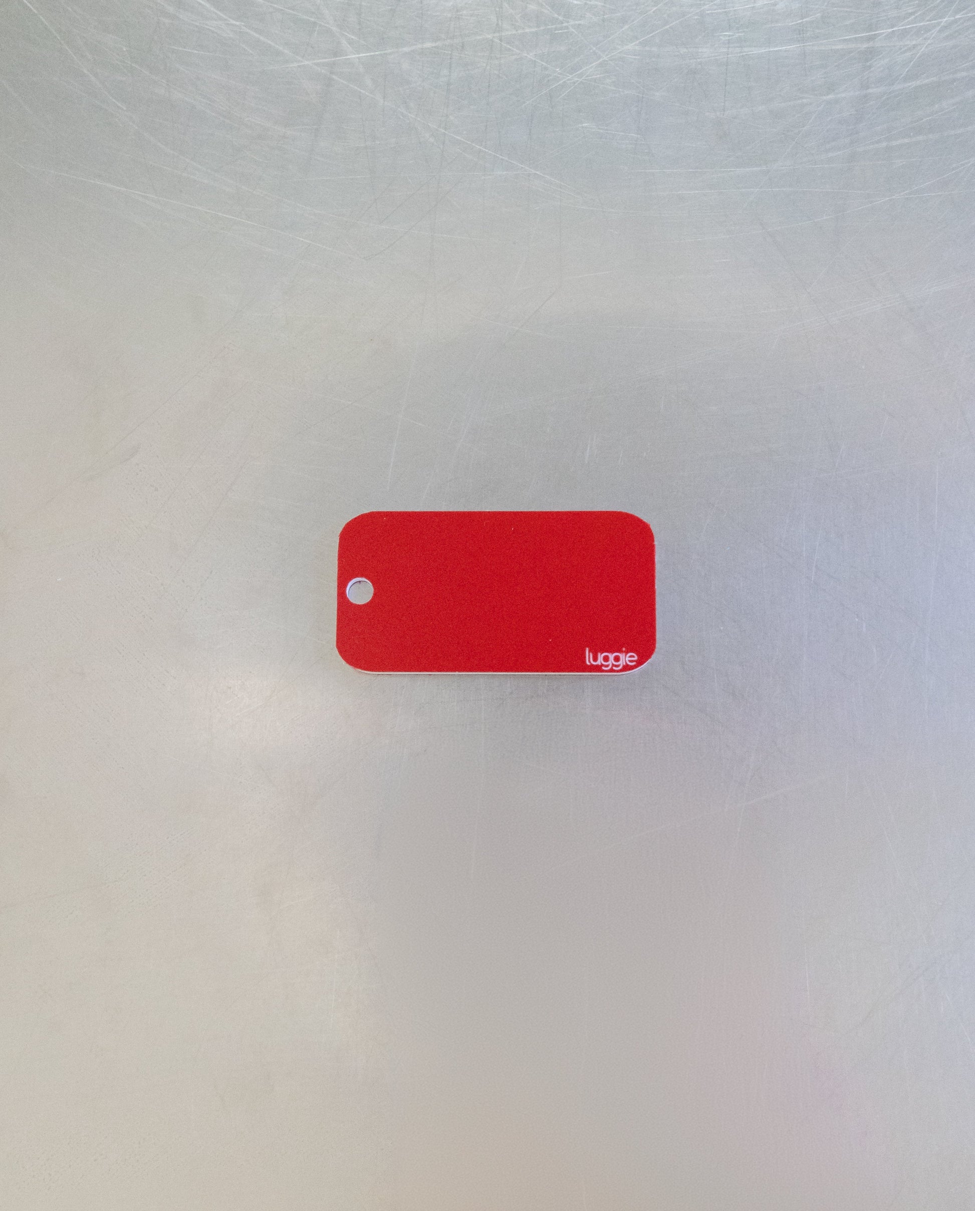 rear of custom key tag with luggie branding
