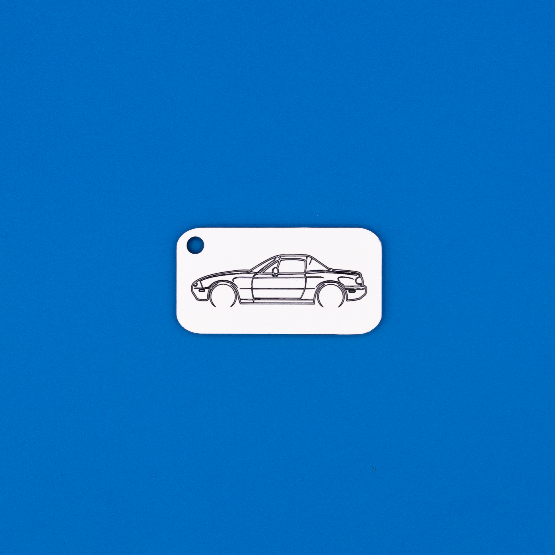 Mazda NA Miata Acrylic Keychain in white with just the hole. 