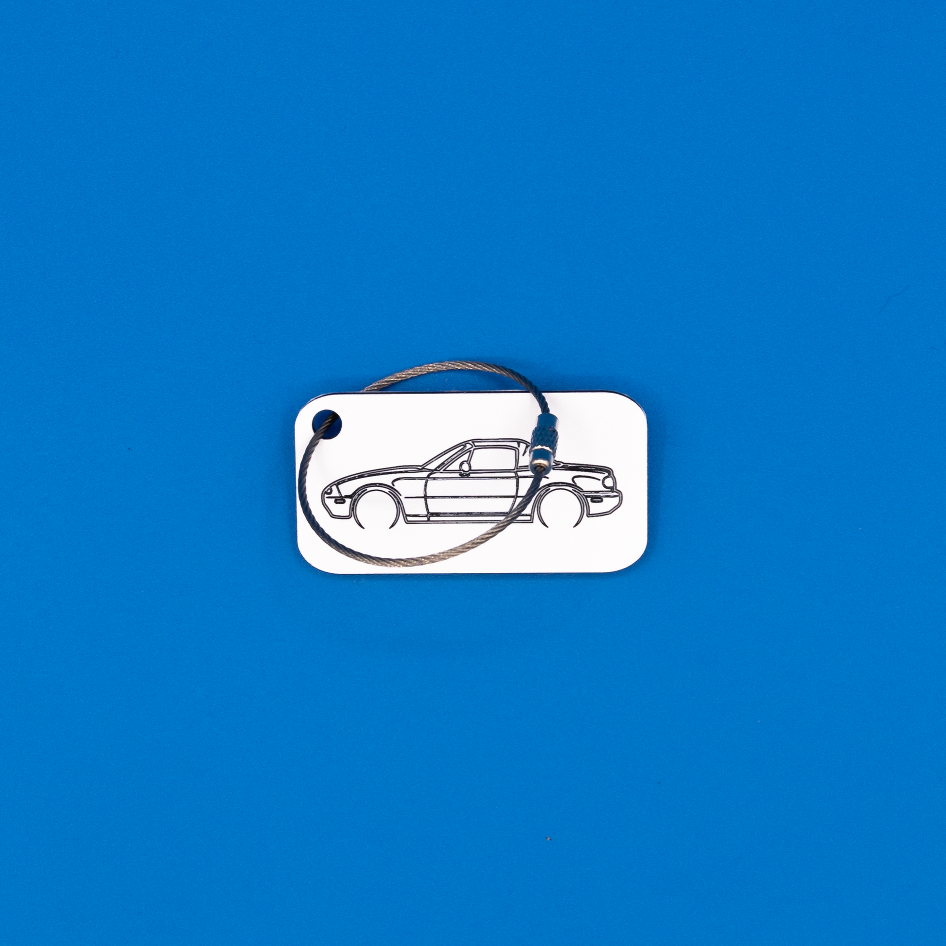Mazda NA Miata Acrylic Keychain in white with a wire loop.